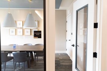 A conference room with a long table and chairs at The Crest at South Point Apartments, Davenport , GA